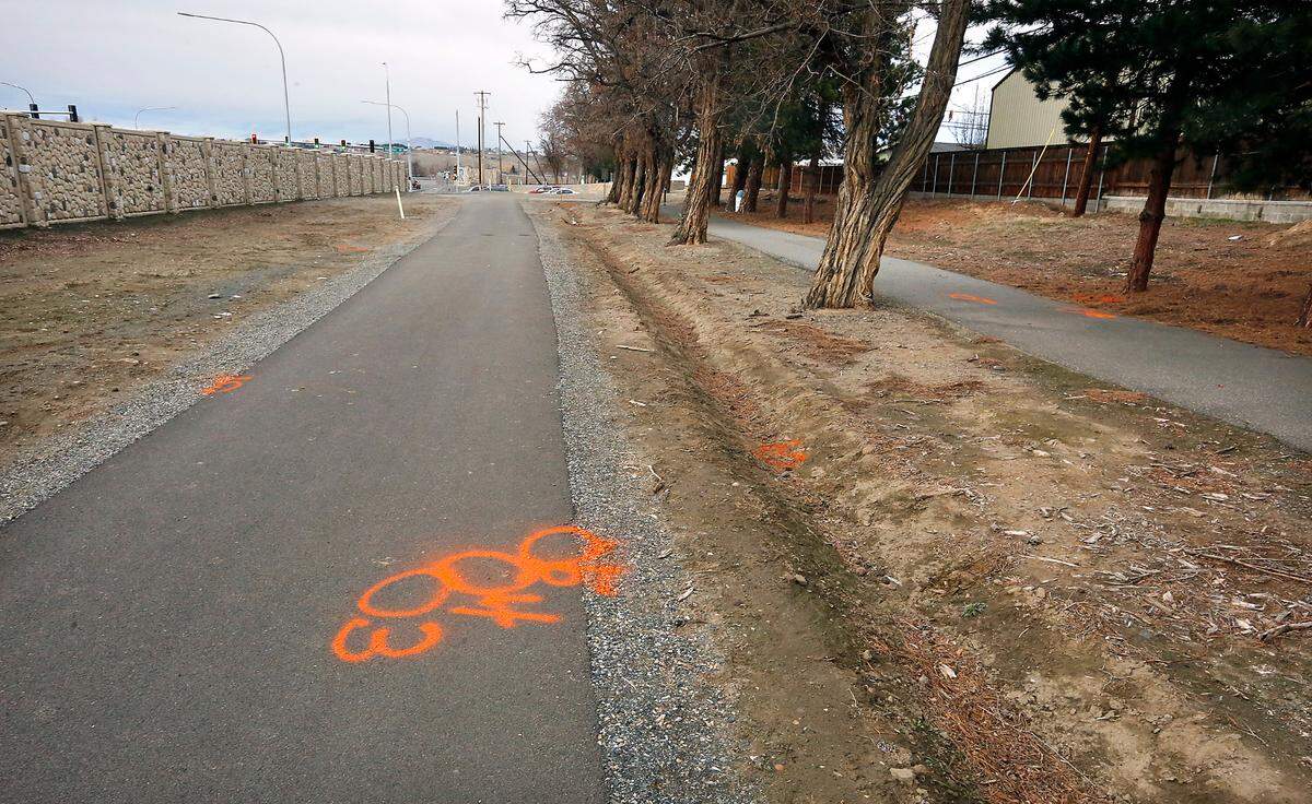 Investigation paint markings show the scene of Monday night’s officer-involved shooting along the path paralleling Highway 240 near Duportail Street in Richland.