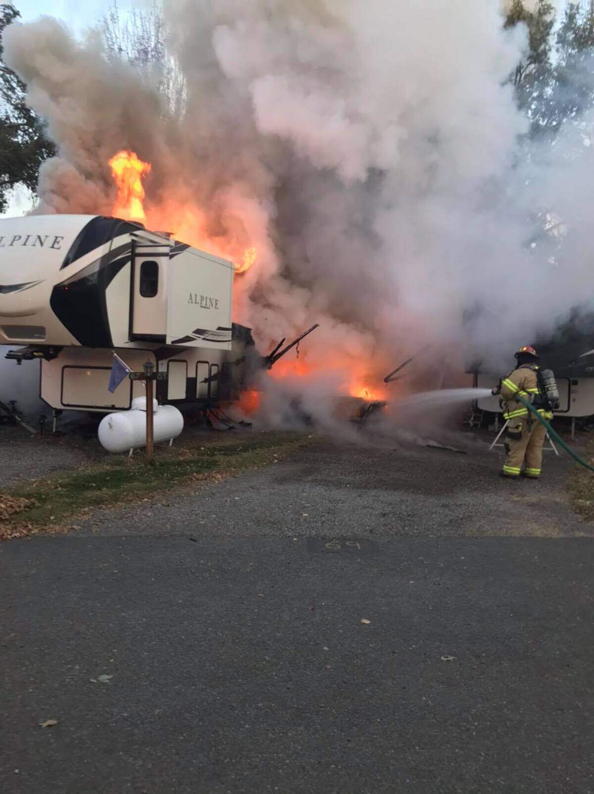 Firefighters battle a blaze at a camper trailer at Beach RV Park on Thursday, Oct. 15.
