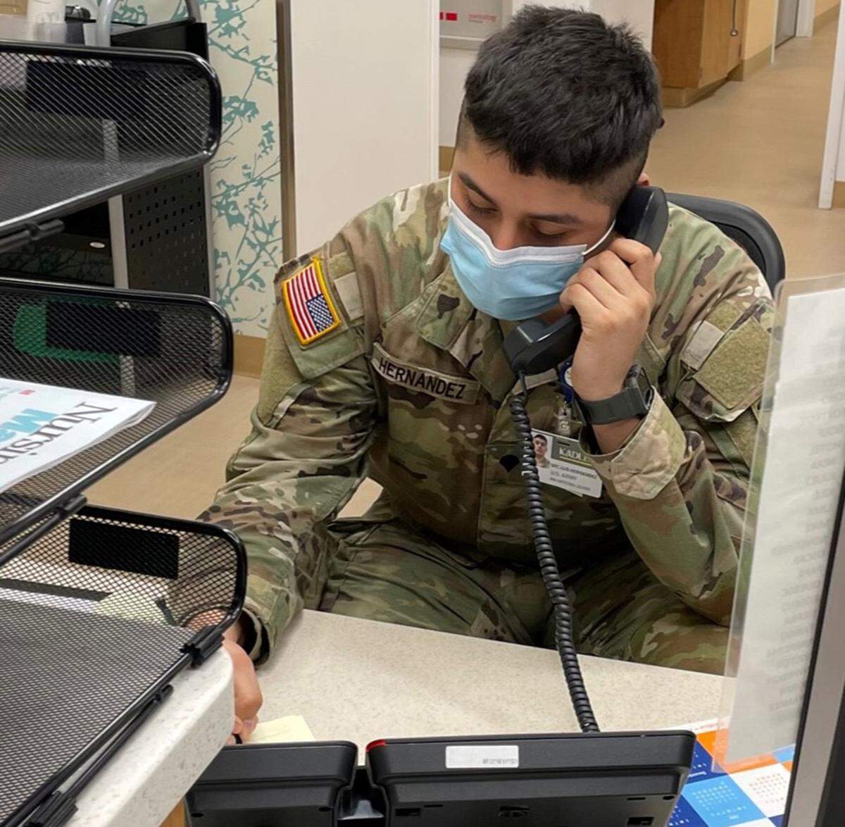 A member of the Washington National Guard assists with phone calls at Kadlec Regional Medical Center in Richland. About two weeks ago, Gov. Jay Inslee activated the National Guard to help hospitals around the state with the current COVID-19 surge. 