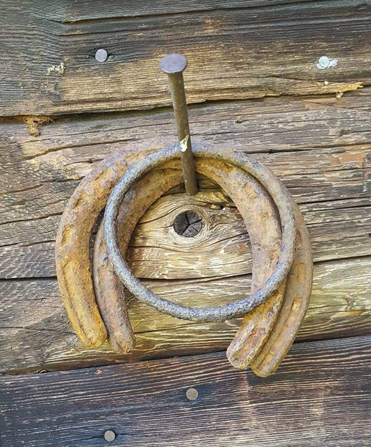 Horseshoes hang on a nail at the 100 year old cabin.
