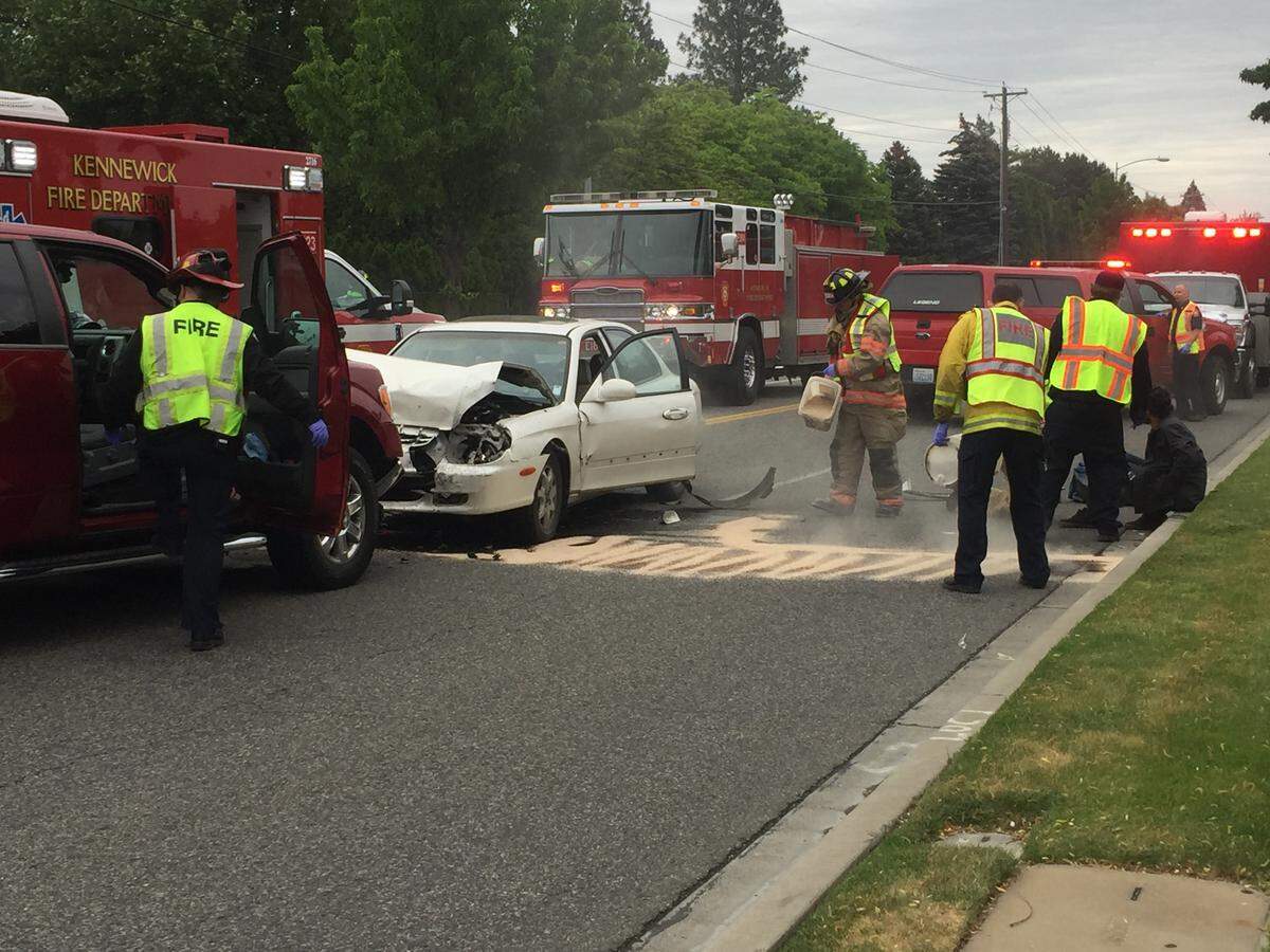 Firefighters and police are on the scene of a two-car crash that left two drivers hurt.