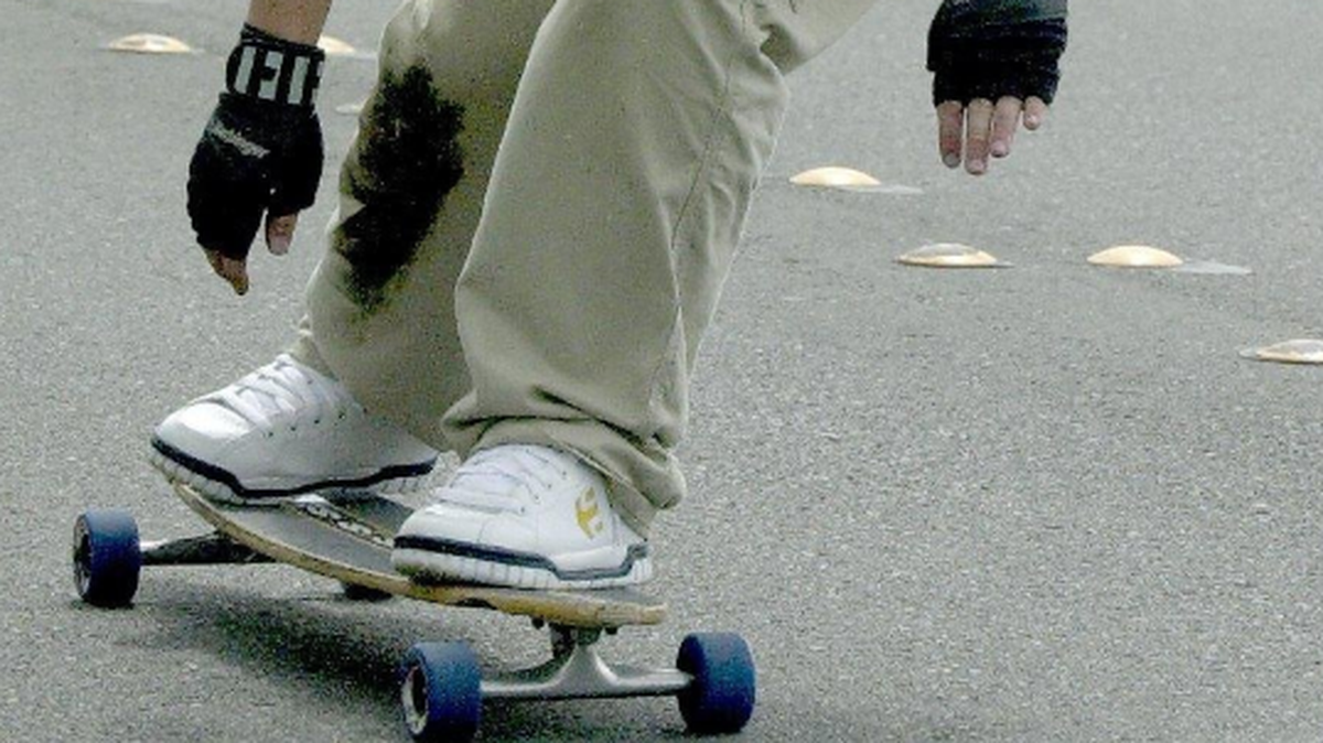 A long board rider is accused of pulling a gun after hitting a bystander and falling on Sunday in Kennewick.