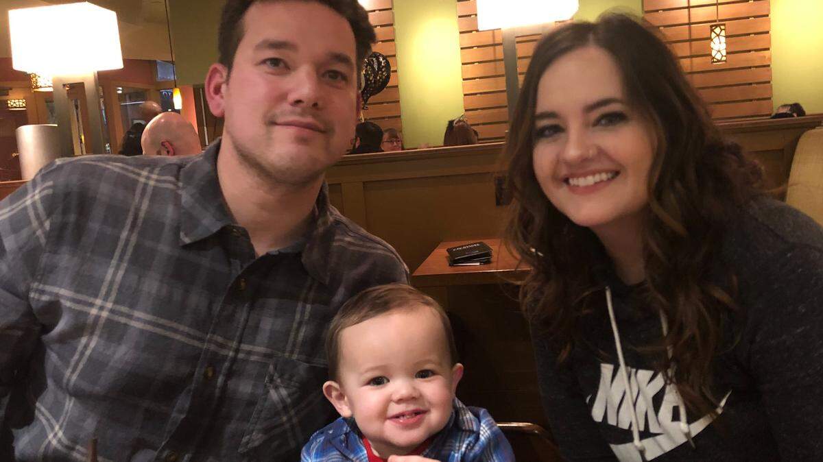 Nicholas and Nikki Augustavo sit with their young son Kaysen. Hanford firefighters are raising money for the Hanford firefighter days after the toddler died.