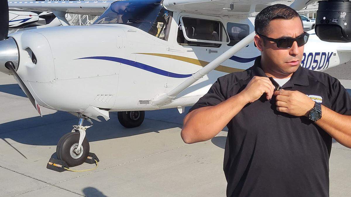 Trooper Daniel Mosqueda prepares to be interviewed in front of the Washington State Patrol plane. Troopers had help in the air this weekend as they keep an eye on the roads for Water Follies. 