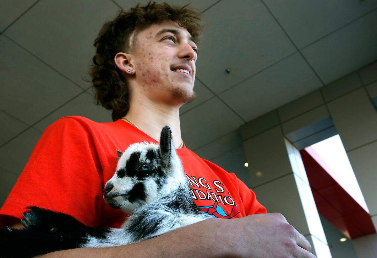 Wishing Star recipient Landen Schroeder, 18, of Pasco holds a goat nicknamed Mo during Wednesday’s announcement of the return of the popular “Send a Friend a Goat” fundraiser. The program raises money for the Wishing Star Foundation that helps grant wishes for kids age, 3 to 21, with terminal or life-threatening conditions.