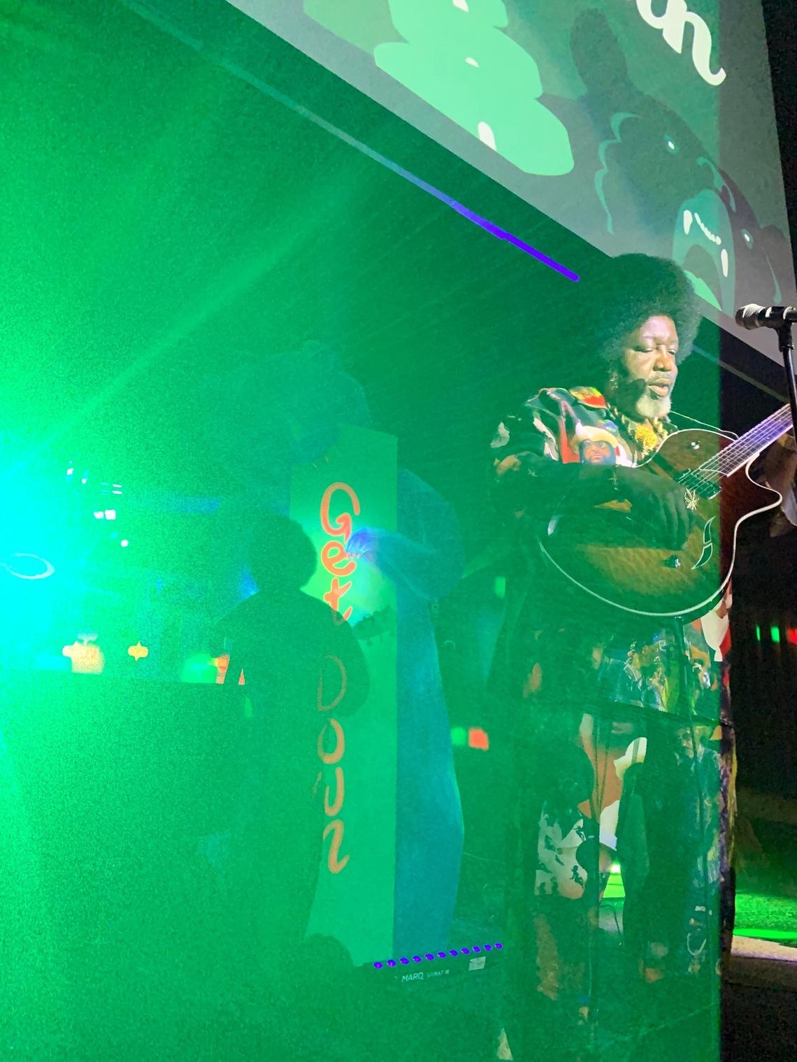Afroman plays a guitar, borrowed from reggae band Naughty Pine, during his set on the Uptown Get Down Main Stage in June 2023 at the Uptown Theatre.