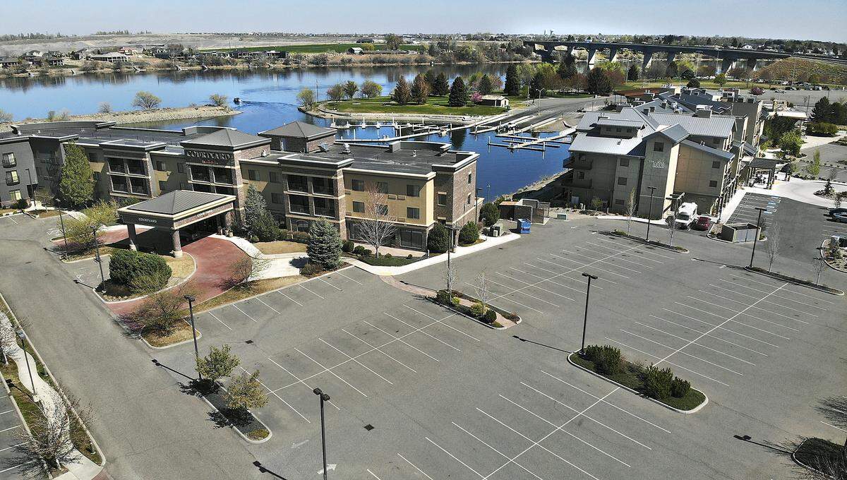The connected parking lot for The Lodge at Columbia Point, right and Courtyard by Marriott hotels in Richland is empty of vehicles because of the impact from the coronavirus outbreak on travelers. The Lodge remains open but is operating with a reduced workforce.