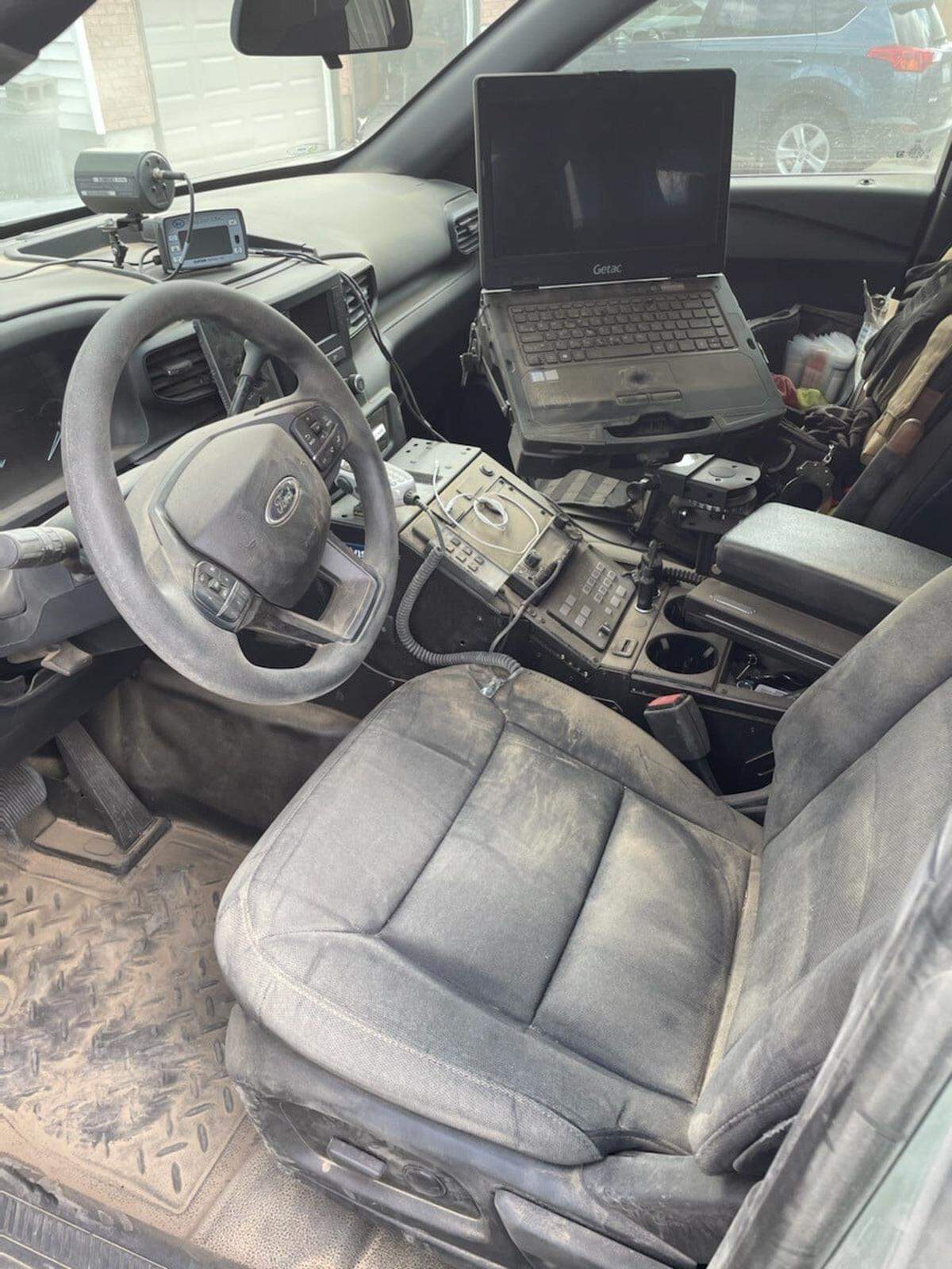 His patrol car was covered with dust after working at an accident scene during the storm.