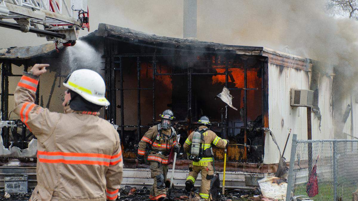 Fire crews battle a blaze Monday that destroyed a home at 1405 S. Elm St., just west of the Benton County Fairgrounds.