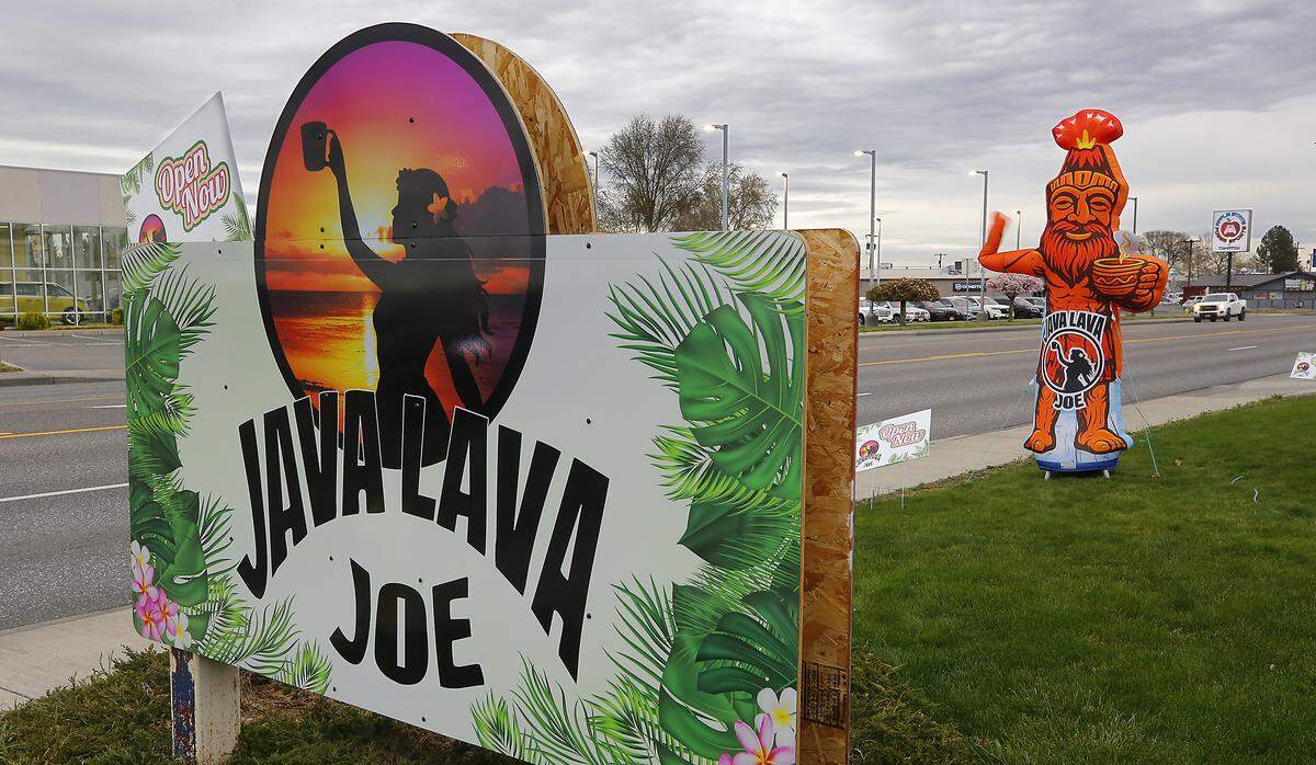The Rodriguez sisters designed their waving inflatable to resemble their father, Cedro, for their new family coffee shop Java Lava Joe on Columbia Drive in Kennewick.