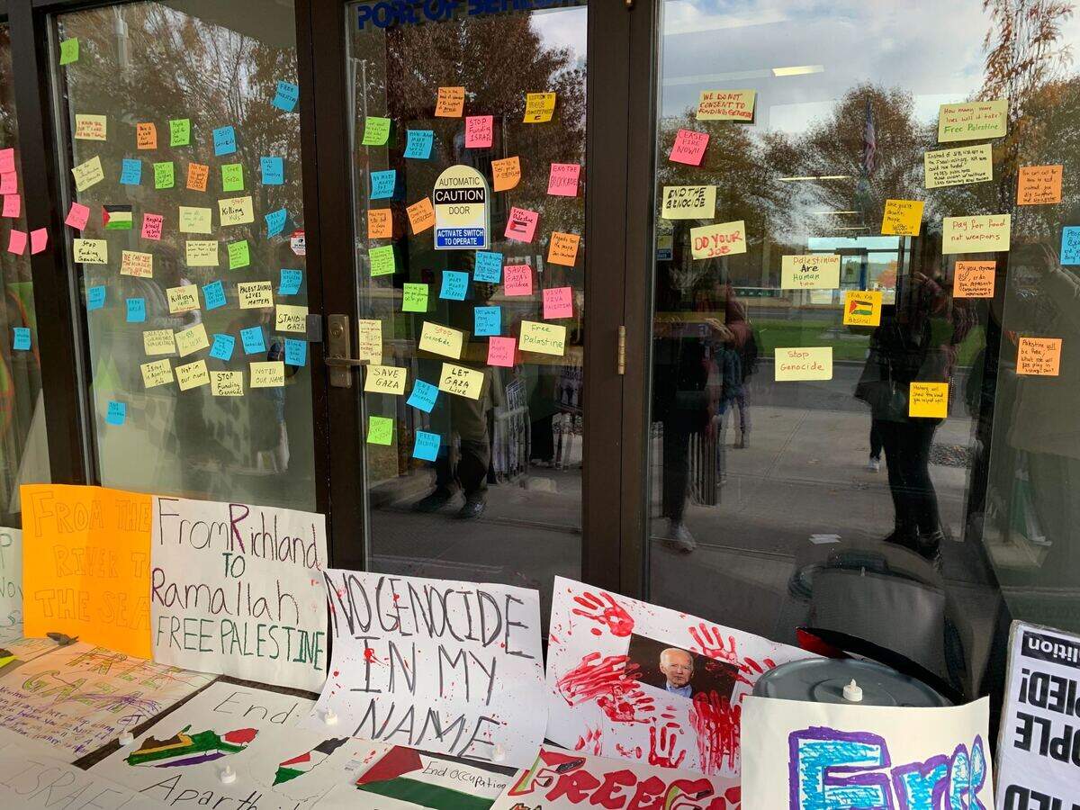 Peaceful protesters covered the entrance to Representative Dan Newhouse’s Richland office on George Washington Way with messages regarding the congressman’s support for Israel.