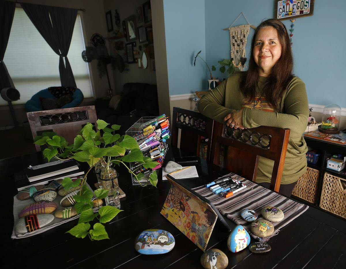 Lynnette Gallegos has found her creative outlet in rock painting and then in a quiet act of kindness she shares her colorfully transformed creations by hiding them around the Tri-Cities for strangers to discover and enjoy. She uses her dining room table in her Kennewick home for her craft making.