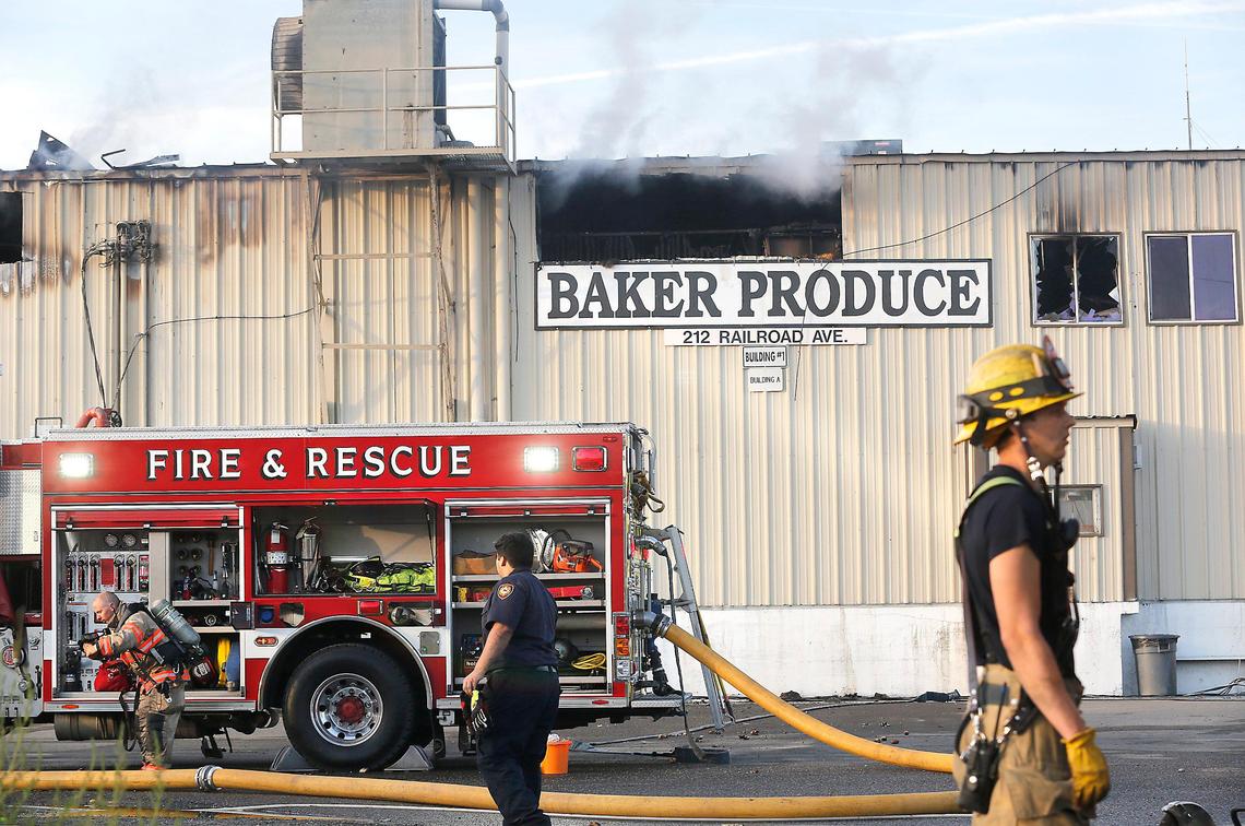 Kennewick firefighters work on the scene early Wednesday morning of an overnight fire at Baker Produce on Railroad Avenue in Kennewick. About half of the roof of the metal building is sagging from the fire’s heat. No one was injured in the blaze. The cause of the fire is under investigation. Watch a video: tricityherald.com/video