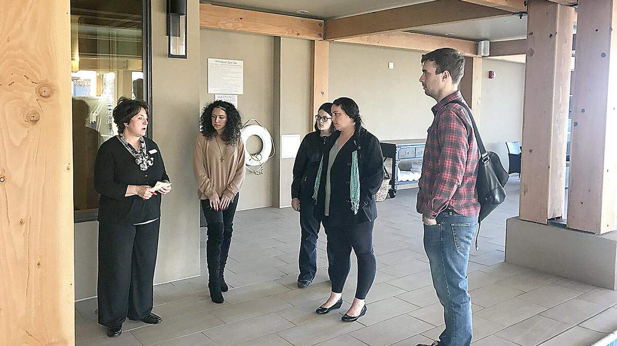 The Lodge at Columbia Point's, Sarah Gallacher, assistant general manager, and front desk employee Adriana Garcia showcase their indoor pool to CBC Hospitality students Jessica Ham, Kara Mercer and Tony Calapristi. Hospitality industry leaders are saying they are looking for people who are trained before they start cooking, serving or working at a hotel front desk.
