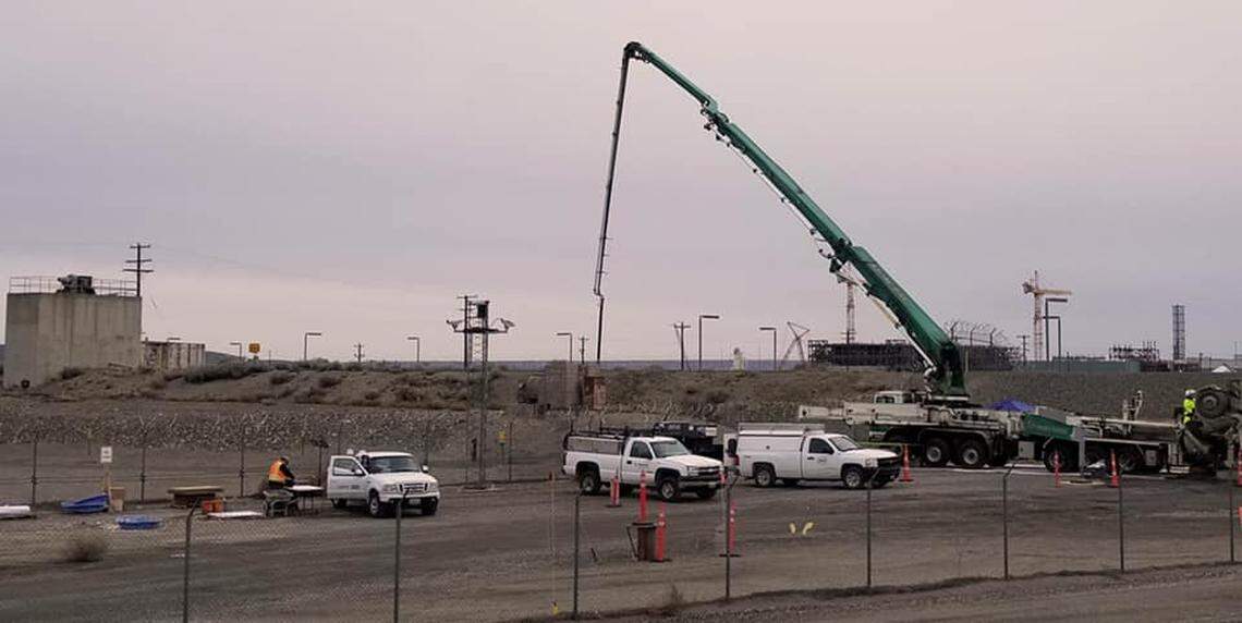 A pump truck with a reach of almost 175 feet delivers concrete-like grout through ports at the top of the second PUREX plant waste storage tunnel, which was at risk of collapsing.