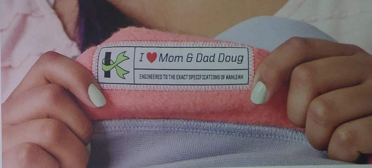 A tag inside Kahleah Corona’s hoodie and tights reflects her love for her mom Irma Corona and dad Doug Knisley, and how the clothing was made to her “exact specifications.”