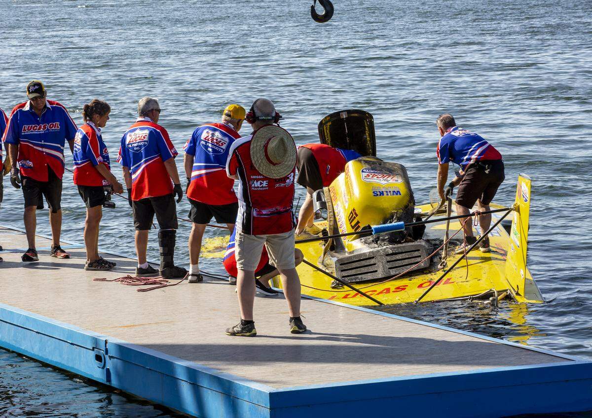 The crew with GP-12 Shellhase hydroplane works to get the boat out of the water after it was brought back to the docks. The fire broke out in the engine of the boat while racing during the HAPO Columbia Cup on Saturday.