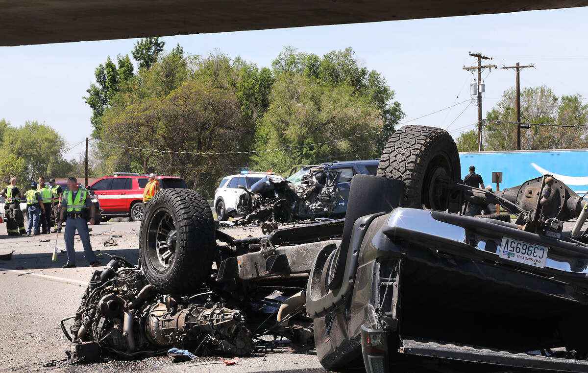 Washington State Patrol troopers investigate the scene of Thursday's double fatal collision at the Lewis Street exit on Highway 395.