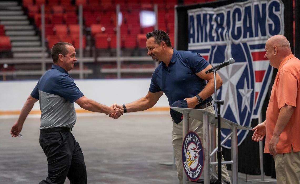 Former Tri-City Americans hockey player Stu Barnes, left, was named new coach of the Tri-Cities Western Hockey League team. He’s being greeted by Olaf Kolzig, middle, and Ams governor Bob Tory during the announcement made at the Toyota Center.