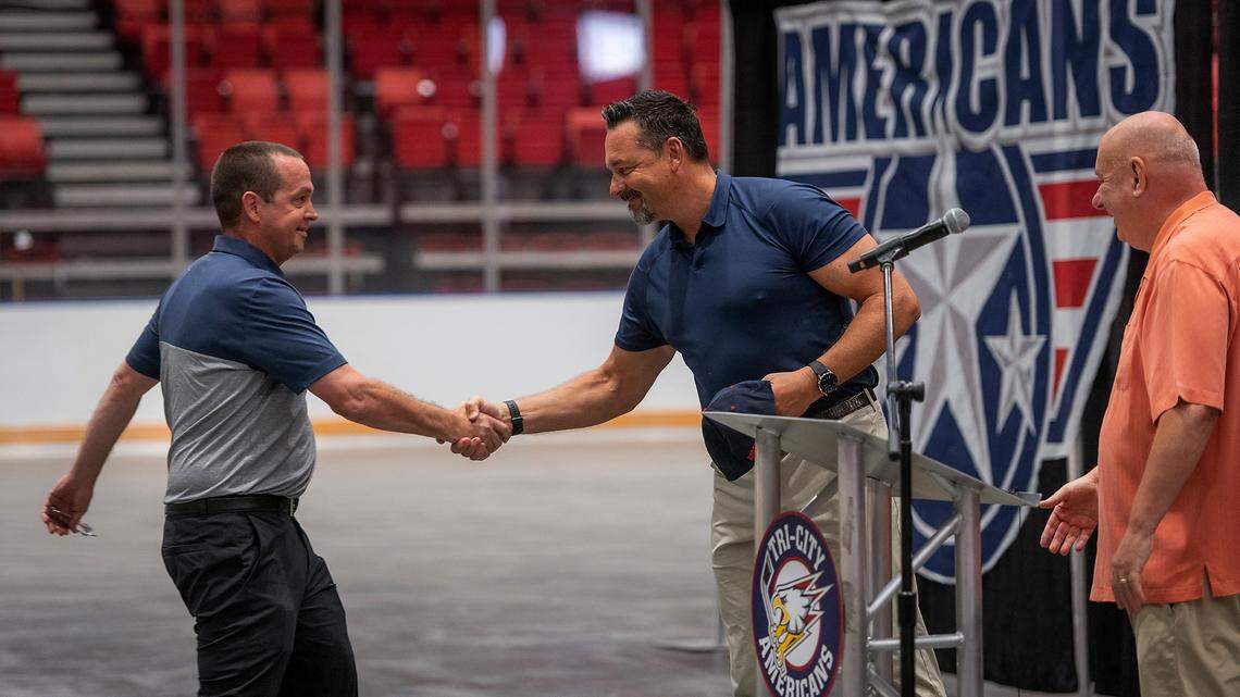 Former Tri-City Americans hockey player Stu Barnes, left, is named new coach of the Tri-Cities Western Hockey League team. He’s being greeted by Olaf Kolzig, middle, and Ams governor Bob Tory during the announcement made at the Toyota Center.
