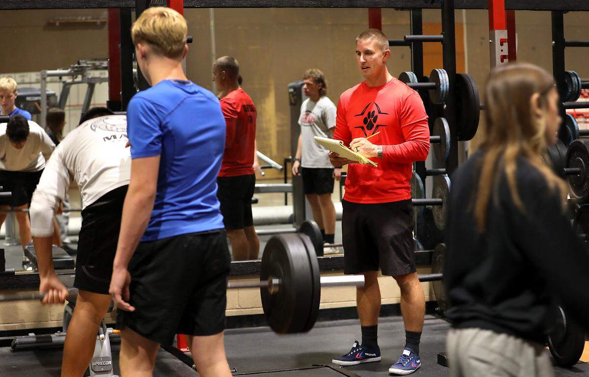 Kris Welch, weight training teacher and River View High School head football coach, recently monitors students in the school's weight training facility. 