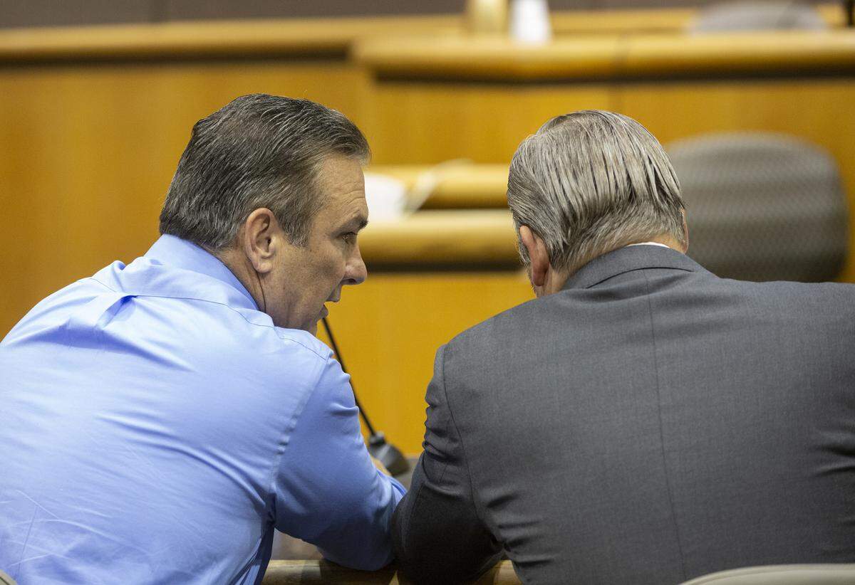 Sheriff Jerry Hatcher talks to his attorney at Benton County Superior Court before Judge Doug Federspiel, a Yakima County Superior Court, for a protection order hearing in October 2019.