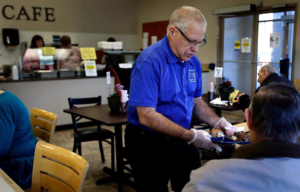 Volunteer Keith Vendramin serves a hot roast beef meal to senior visitor at the Mid-Columbia Meals on Wheels cafe at 1824 Fowler Street.