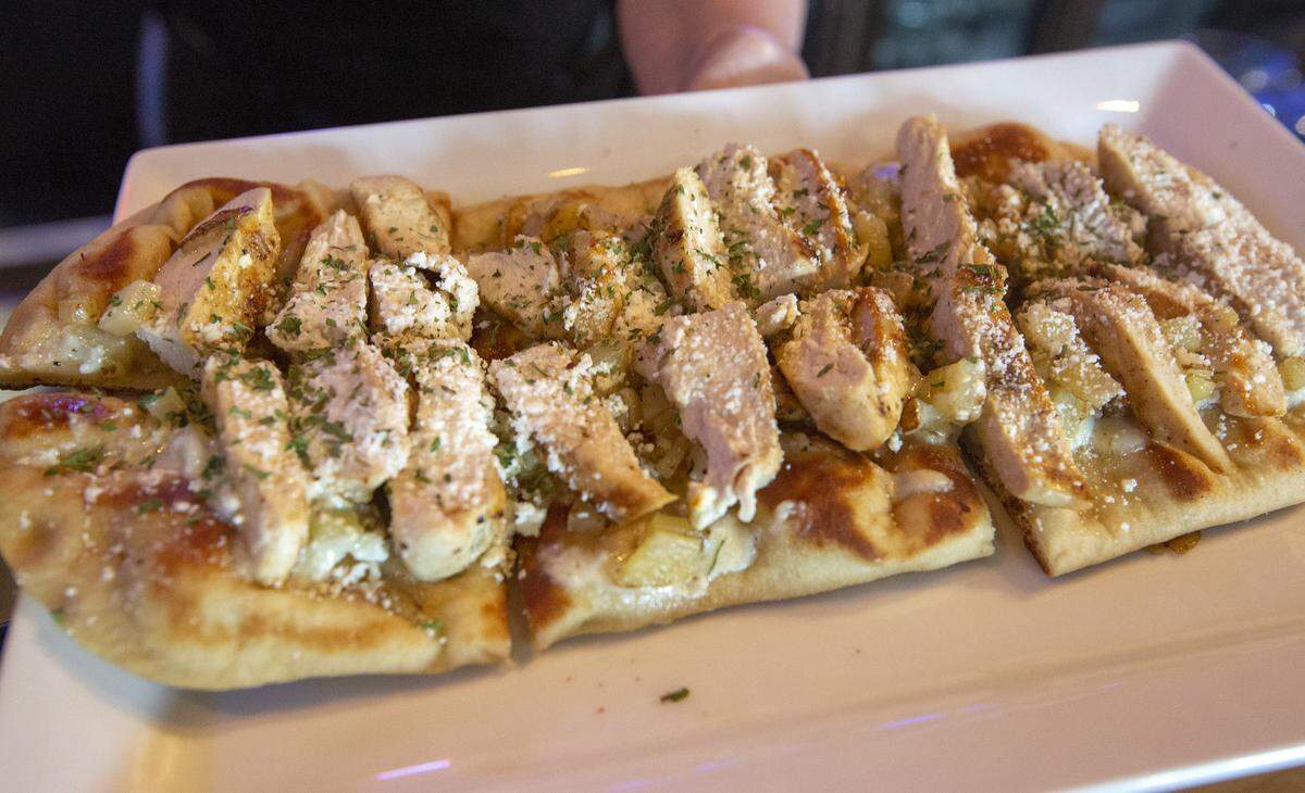 Silo’s rosemary chicken flatbread made with savory cream with rosemary chicken, potatoes, cotija cheese, and garlic confit.