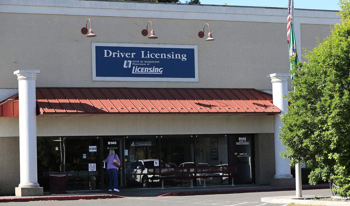 A customer tries to open the front door Monday morning to the The Washington State Department of Licensing Drive Licensing office at 3311 W. Clearwater Ave. in Kennewick. The hours posted on the front door show the office is normally closed on Sunday and Monday.