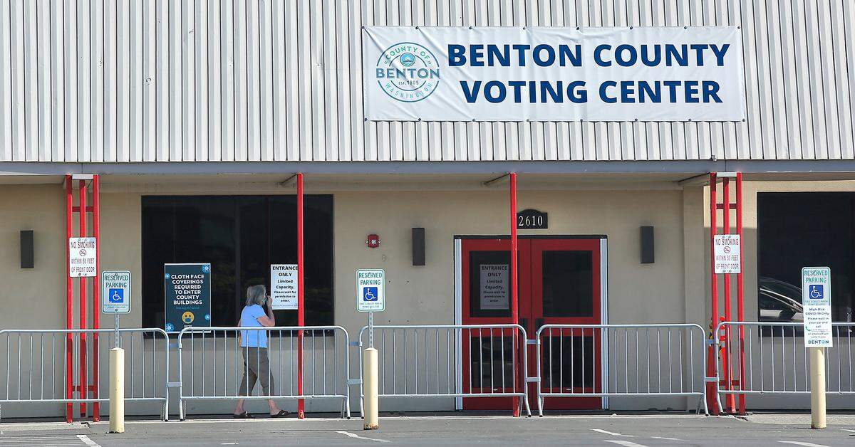 A Benton County resident walks towards the entrance of the newly created voting center at 2610 N. Columbia Center Blvd. in Richland. Watch a video at: tricityherald.com/videos