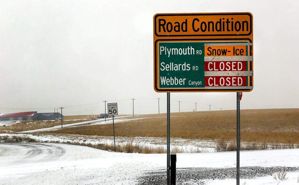 A Benton County sign on Locust Grove Road, just off Interstate 82 south of Kennewick, warns drivers of road closures and conditions after an overnight snowstorm coated the Tri-Cities creating hazardous driving conditions in many areas.