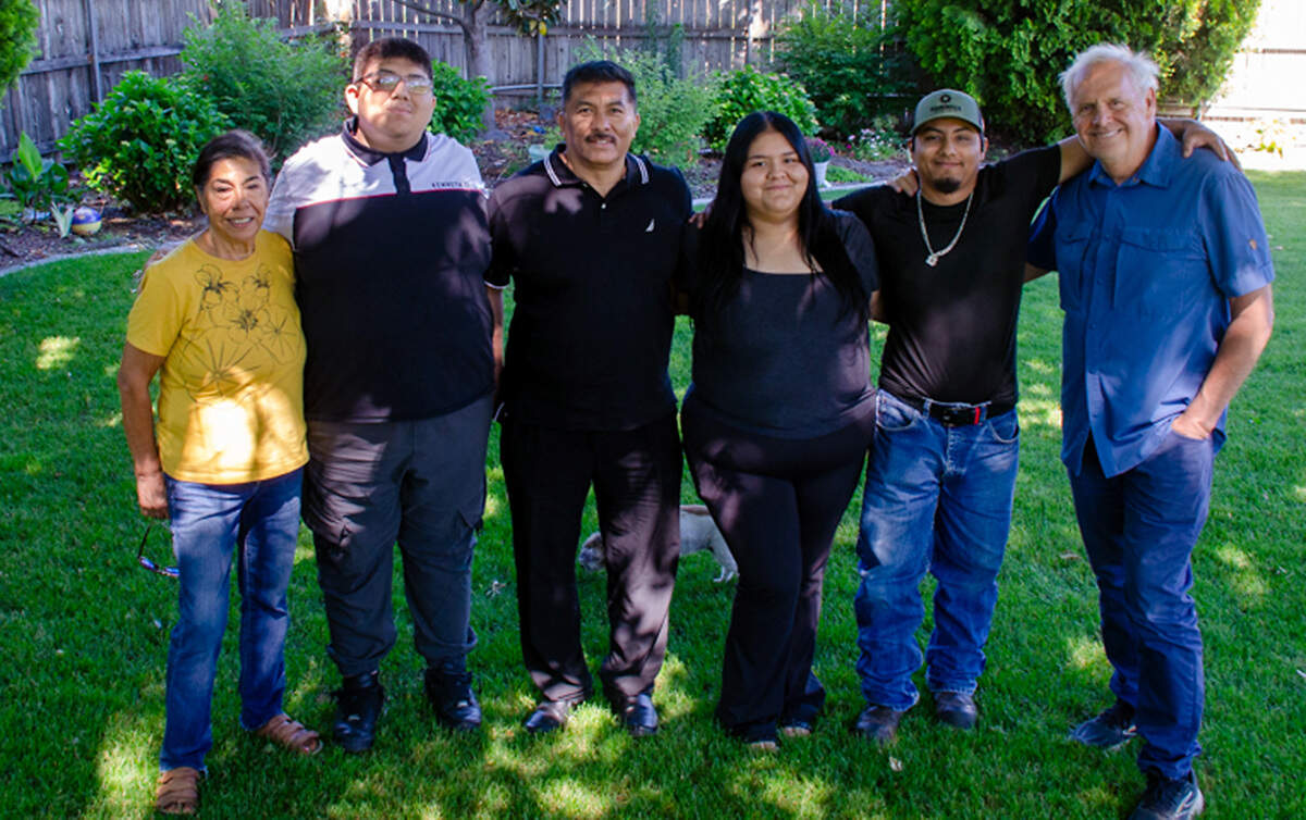 Translator Ana Armijo, left, and retired Benton County Prosecutor Andy Miller, right, pose for a photo with the Campos family on Sunday, June 7.