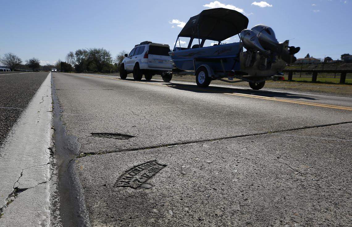 Vehicles drove past a pair of historic concrete stamp in Kennewick's Columbia Park.