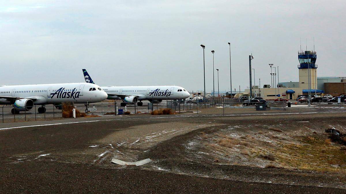 Two Alaska Airlines jet planes sit on the Tri-Cities Airport tarmac Monday morning after being diverted to Pasco Sunday night, according to Tri-Cities Airport Director Buck Taft. The diversions came as the Seattle-Tacoma International Airport was forced to cancel 364 flights because of winter weather.