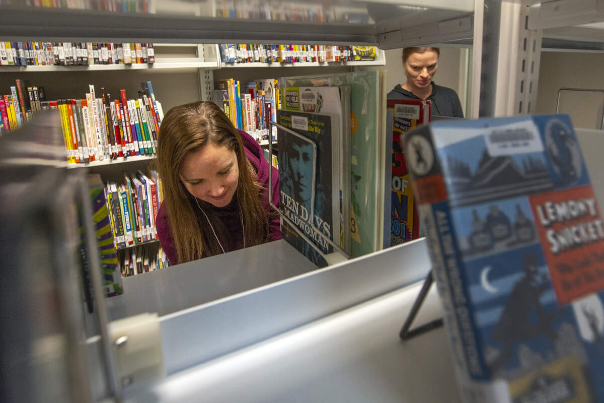 Charity Lee, left, program manager at the West Richland branch of the Mid-Columbia Libraries, and librarian Sarah Johnson organize books Tuesday at the temporary library at West Richland’s public works building, just behind the permanent branch at 3803 Van Giesen St. The temporary library opens to the public ahead of schedule today and will be used during the remodeling project.