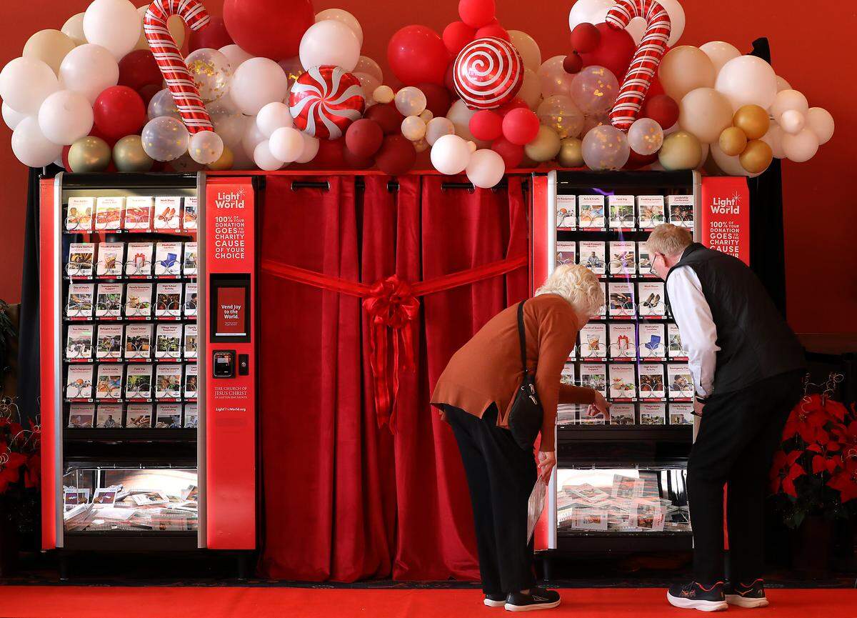 Janet and Dennis Scott of Richland study the choices of one of two Giving Machines stationed in the lobby of the Fairchild Cinemas Queensgate in Richland. 