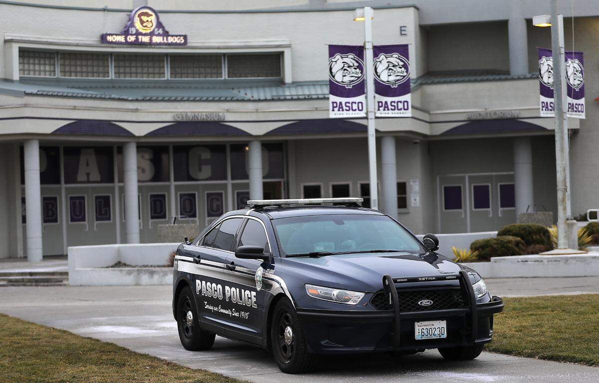 A Pasco Police patrol car sits outside the gymnasium of Pasco High School for extra security at a basketball game this winter.