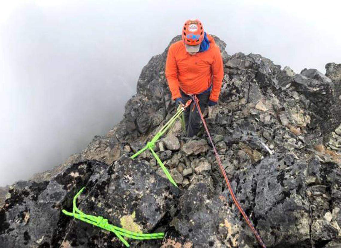 An investigator testing the anchor with a backup belay. Dewey Peak, two weeks after the accident. The investigator is standing where Stephen may have been when he fell.