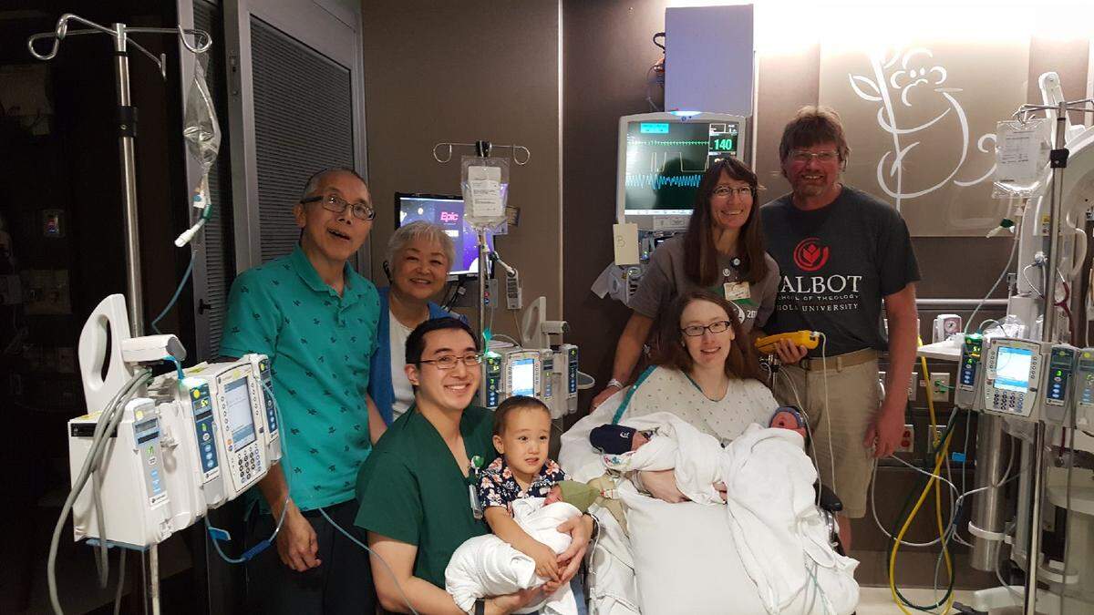 Grandparents Andy and Dayle Lum, left, and Mashell and Brian Talbot stand with the family.