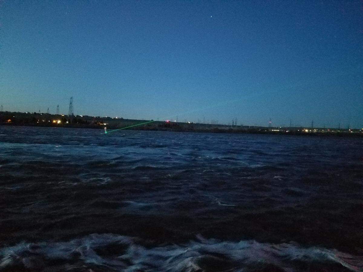 This laser at McNary Dam emits a bright green light that birds perceive as a solid object, which causes them to fly out of the way.