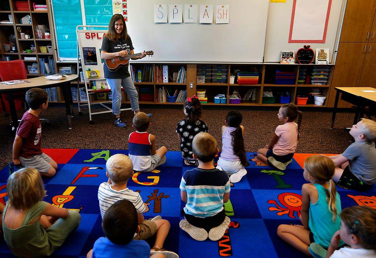 Teacher Julie Bruce plays her ukulele during a sing-along with her new Kennewick kindergarten students at Amon Creek Elementary School.