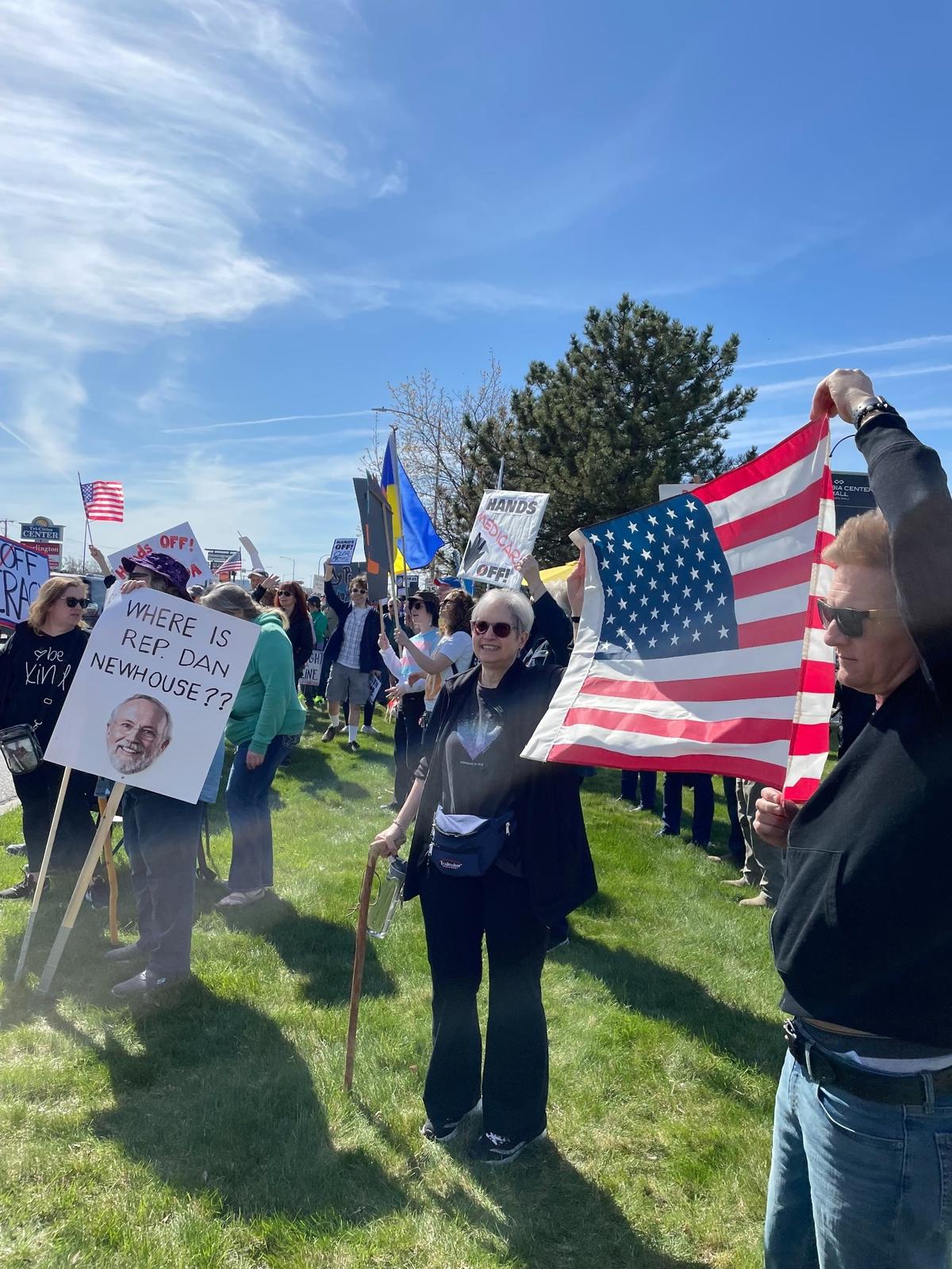 Hundreds of people lined Columbia Center Boulevard in Kennewick Saturday for a “Hands Off! Kennewick Fights Back,” to protest Trump administration policies.