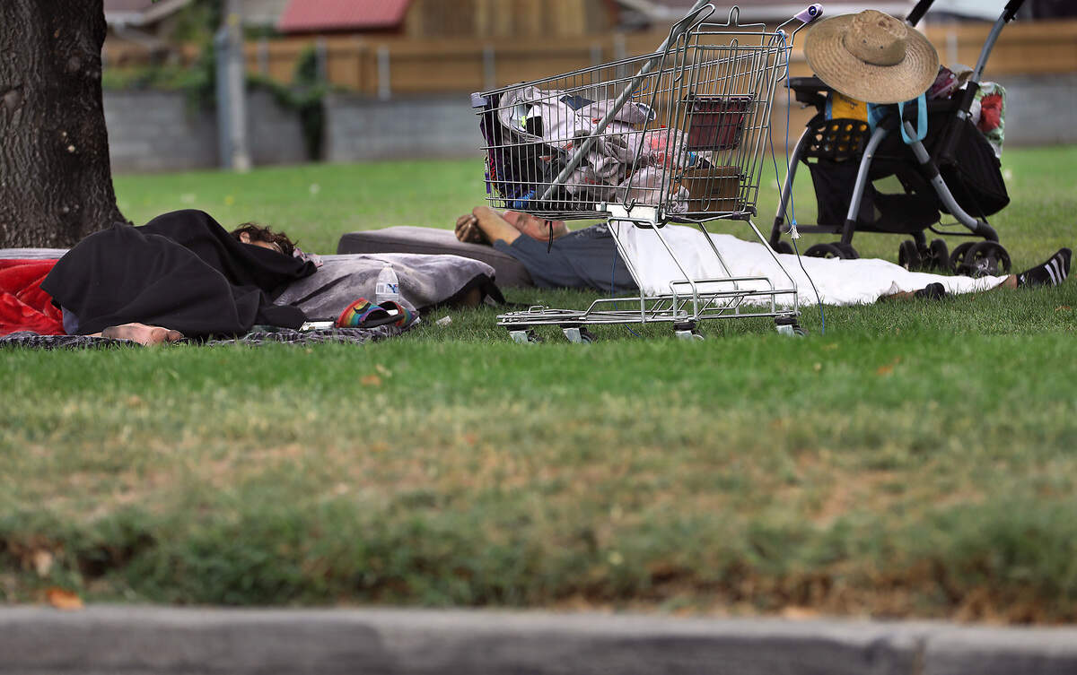 The homeless sleep on the ground under the trrees near their belongings recently at Yelm Park in Kennewick.