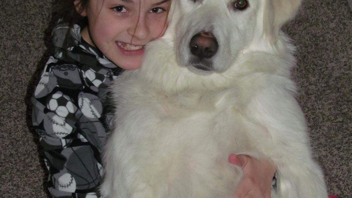 Sapphire McDonald hugs her best friend, a rescued Great Pyrenees.