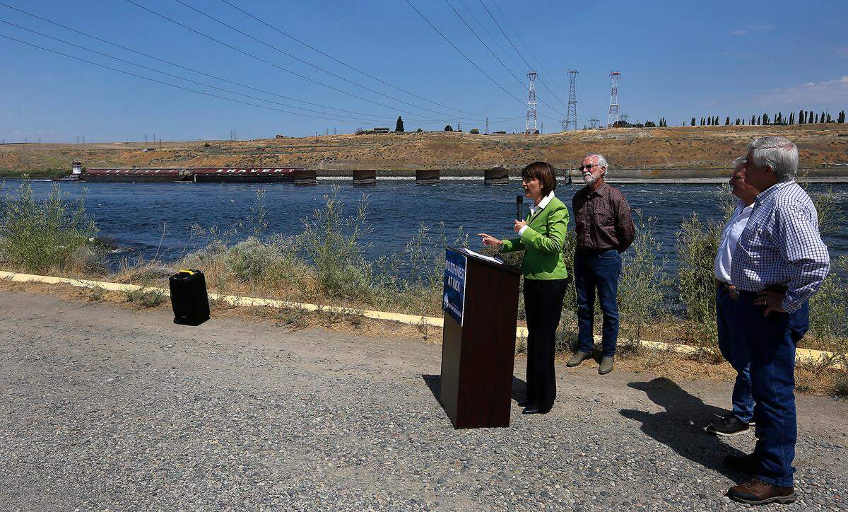 A barge prepares to enter the locks at Ice Harber Dam while Cathy McMorris-Rodgers, R-Wash., joins congressman Dan Newhouse, R-Wash., Mike Collins R-Georgia, and Cliff Bentz, R-Ore., at a news conference Monday.