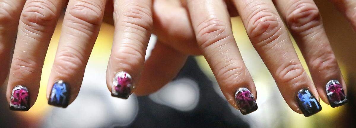 Debbie Deweber of Pasco shows off her fingernails painted in tribute to one of her passions, WWE wrestling, in honor of the Feb. 16 event in Kennewick. Watch a video at: tricityherald.com/videos
