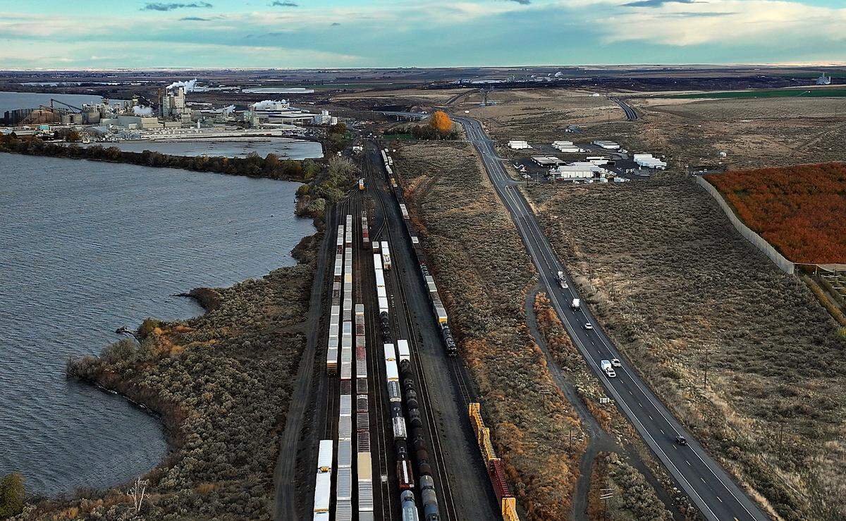 Traffic streams along Highway 12 past the Packaging Corporation of America plant, left, and the Wallula Gap Business Park in Walla Walla County.