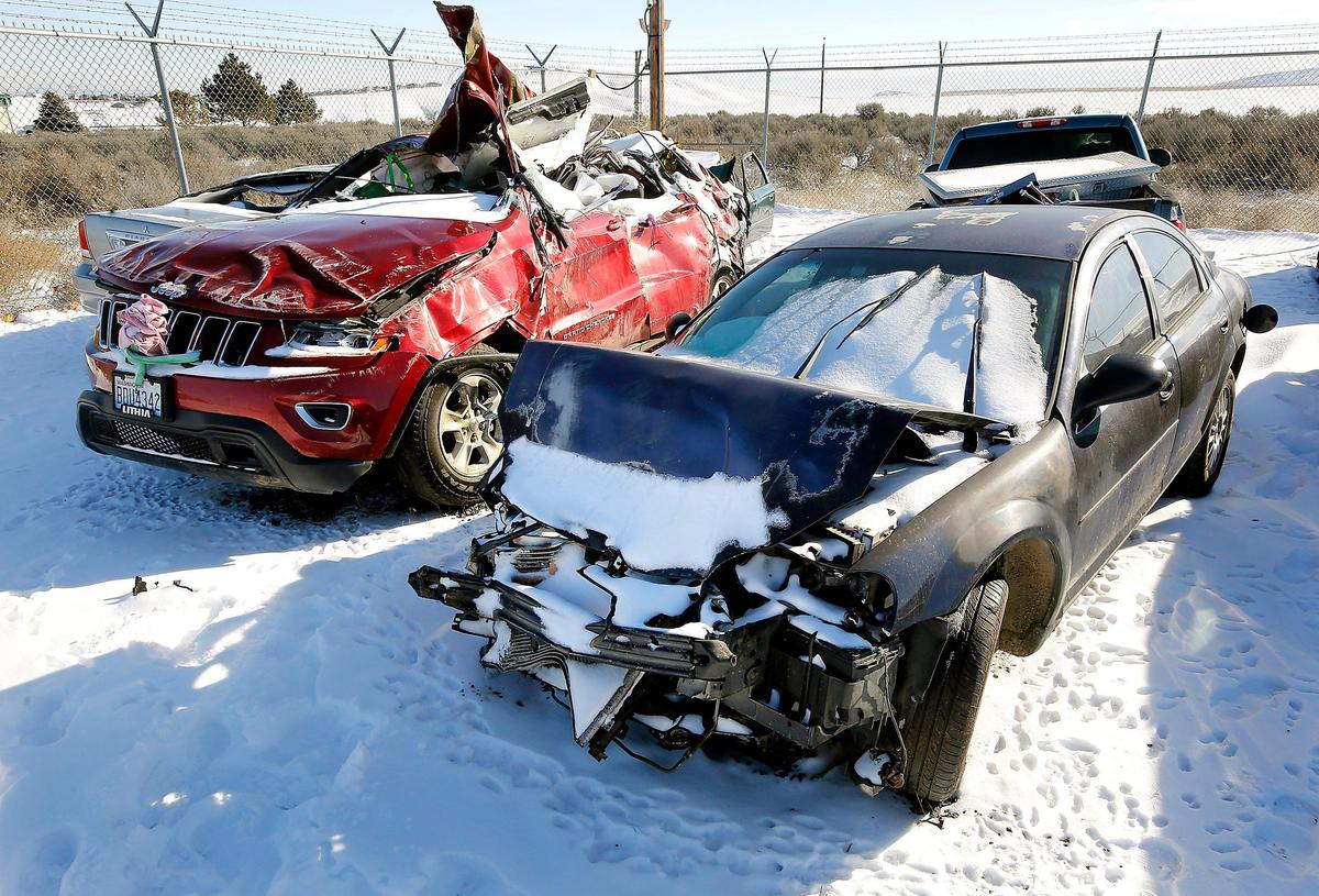 The Chrysler Sebring allegedly driven by fatal hit-and run driver Eduardo Lopez sits adjacent to the red Jeep Grand Cherokee driven Kimberly Youngblood in the Washington State Patrol impound lot in Kennewick. Youngblood, 44, of Benton City died in the Feb. 2 crash.