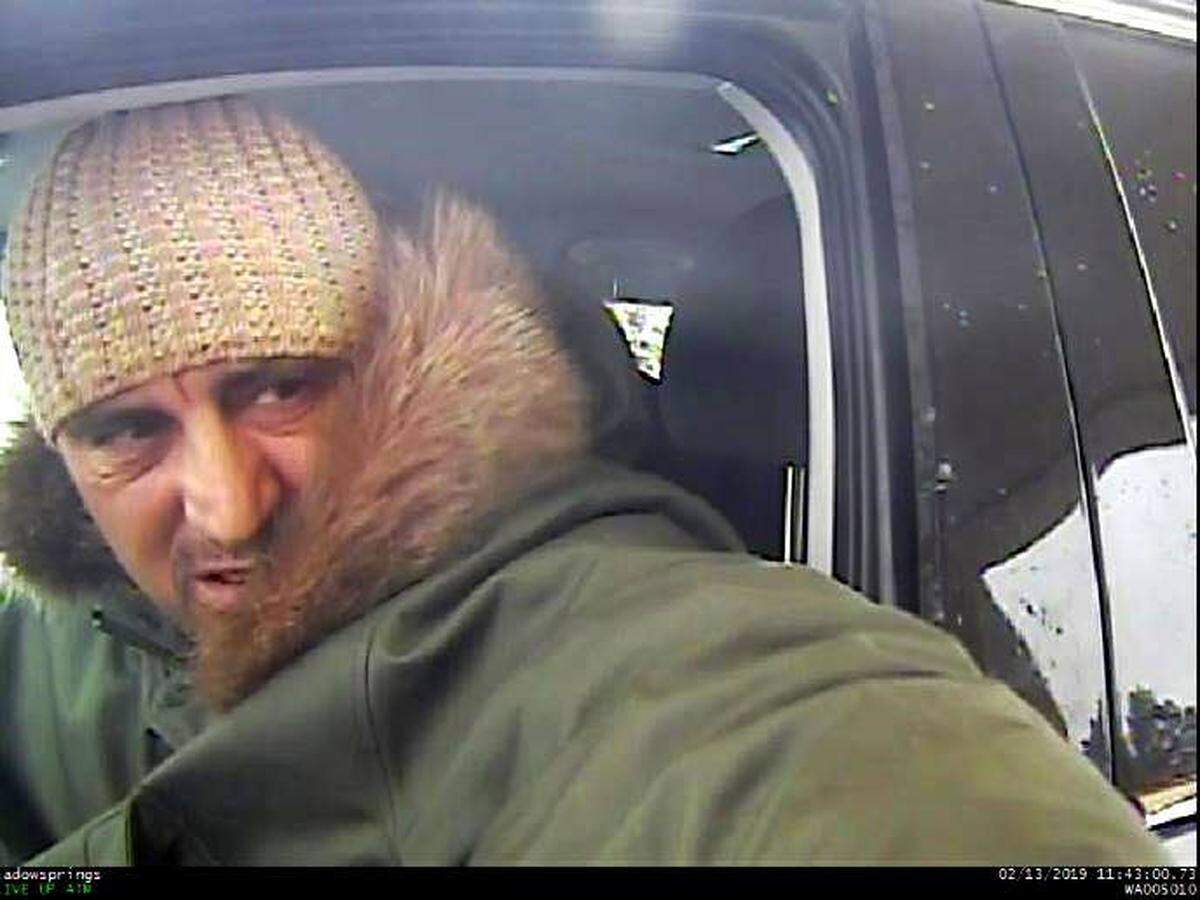 The man in the green coat, suspected of siphoning money from Tri-Citians’ bank accounts in February, has been arrested in Portland.