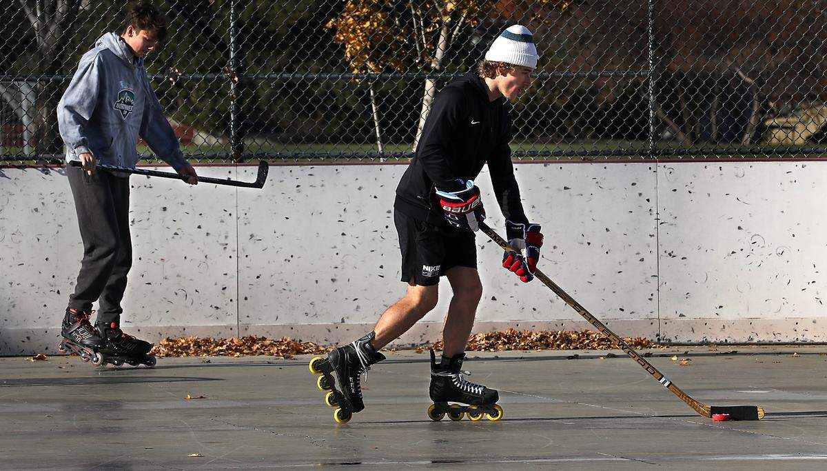 Friends Michael Martin, left, and Tristan Hale, both of Kennewick, dodge piles of wind blown leaves that have accumulated at the outdoor roller hockey rink at Highlands Grange Park in Kennewick. The sun was brightly shining and there was only a light wind for their informal play on Friday, but the National Weather Service is predicting wind gusts of up to 40 mph are forecast Saturday in the Tri-Cities.